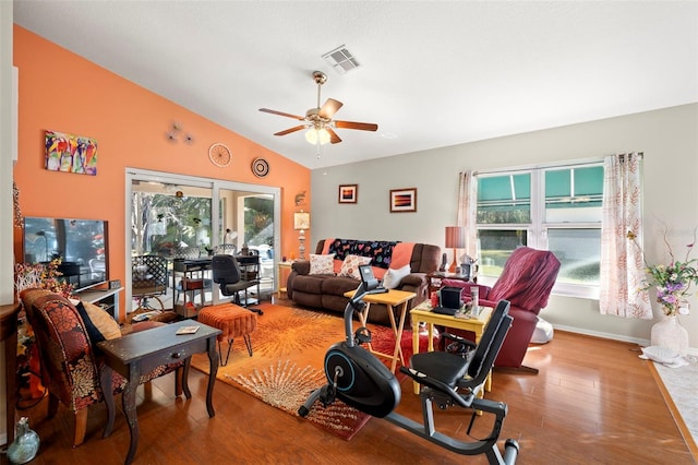 living room with hardwood / wood-style floors, ceiling fan, and lofted ceiling