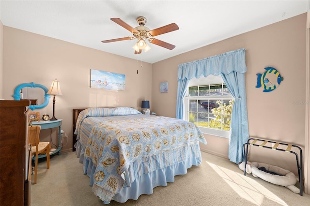 bedroom with ceiling fan and light carpet