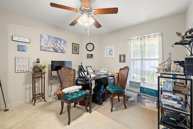 carpeted office featuring ceiling fan