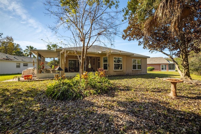 rear view of house with a lawn