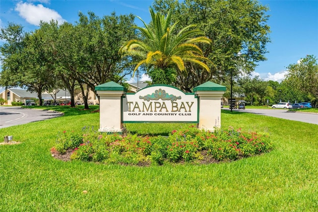 community sign featuring a lawn