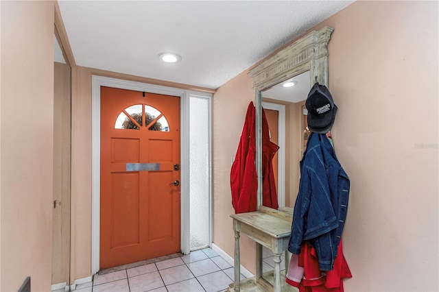 tiled foyer entrance with a textured ceiling