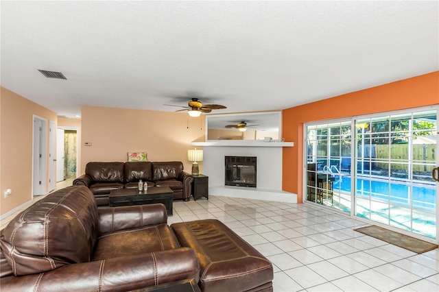 living room with ceiling fan and light tile patterned flooring