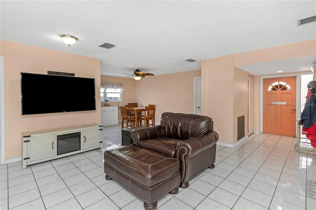 living room featuring ceiling fan and light tile patterned floors