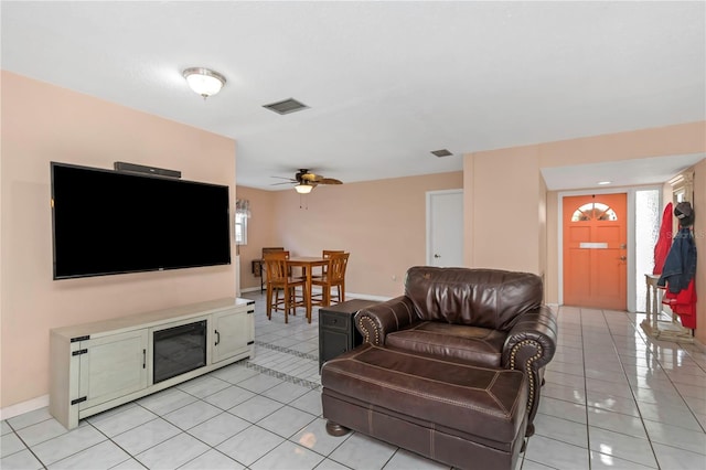 living room featuring light tile patterned floors and ceiling fan