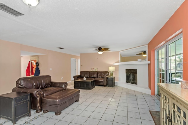 tiled living room featuring ceiling fan