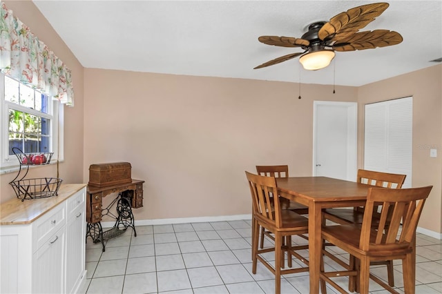 tiled dining space featuring ceiling fan