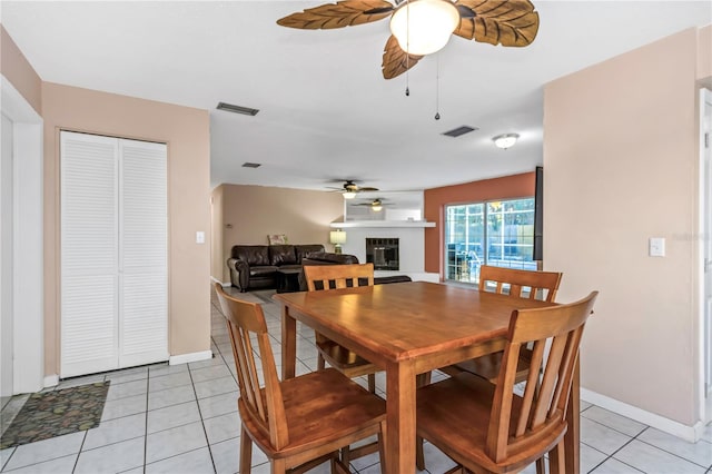 tiled dining area with ceiling fan