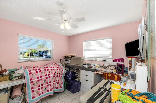 tiled bedroom featuring a textured ceiling and ceiling fan