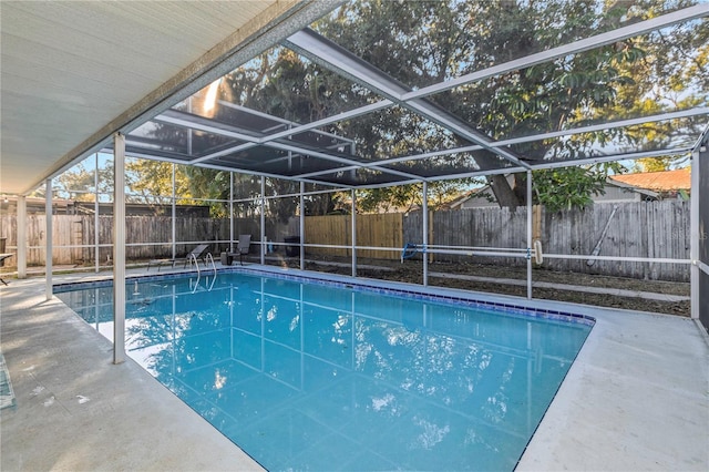 view of swimming pool with a lanai and a patio area