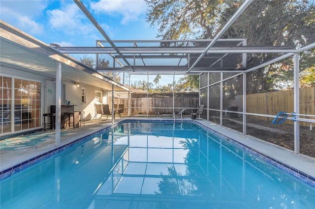 view of swimming pool with a lanai and a patio area