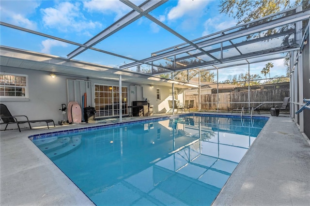 view of swimming pool with a lanai and a patio area