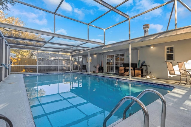 view of swimming pool with glass enclosure and a patio area