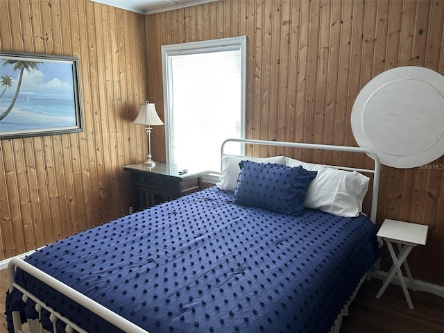 bedroom featuring wooden walls