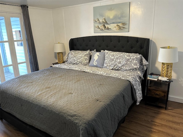 bedroom with dark hardwood / wood-style flooring and crown molding