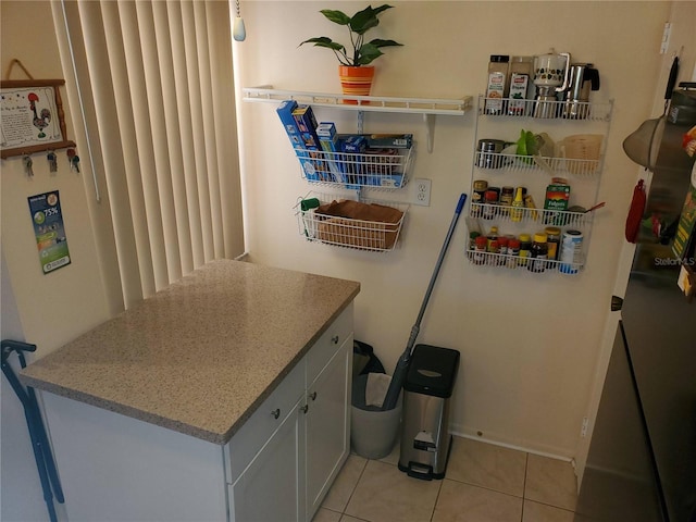 interior space featuring white cabinets and light tile patterned floors