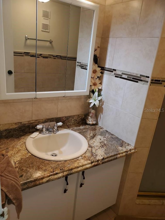 bathroom with decorative backsplash and vanity