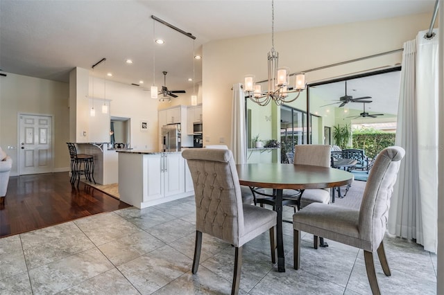 dining room featuring ceiling fan with notable chandelier