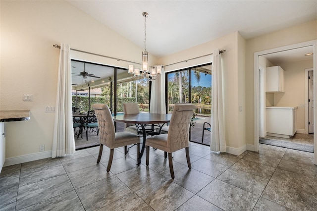 dining area featuring ceiling fan with notable chandelier, vaulted ceiling, and plenty of natural light