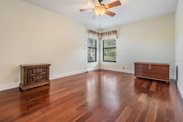 unfurnished room with ceiling fan and dark wood-type flooring