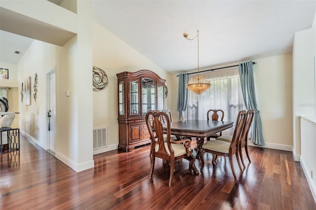 dining area with vaulted ceiling, dark wood-type flooring, and an inviting chandelier