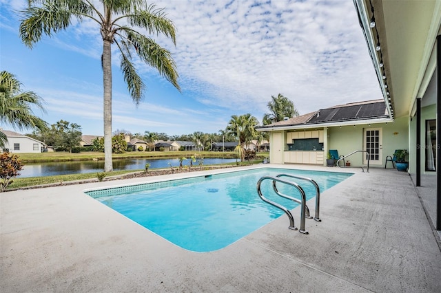 view of pool with a water view and a patio