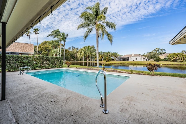 view of swimming pool featuring a water view and a patio