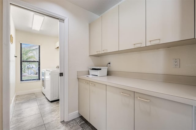 laundry area with light tile patterned flooring and washing machine and clothes dryer