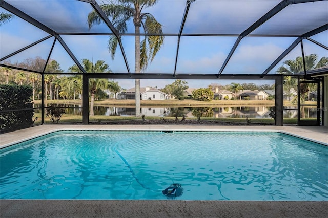 view of swimming pool featuring a water view and a lanai