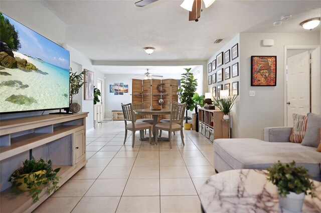 tiled dining area featuring ceiling fan