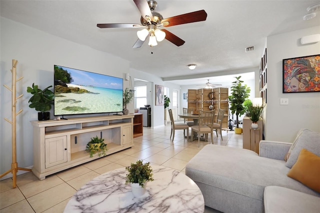 tiled living room featuring ceiling fan