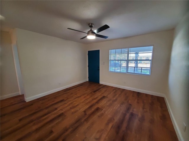 empty room featuring ceiling fan and dark hardwood / wood-style flooring