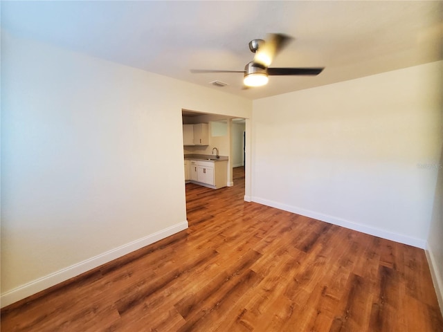 spare room featuring ceiling fan, sink, and light hardwood / wood-style floors