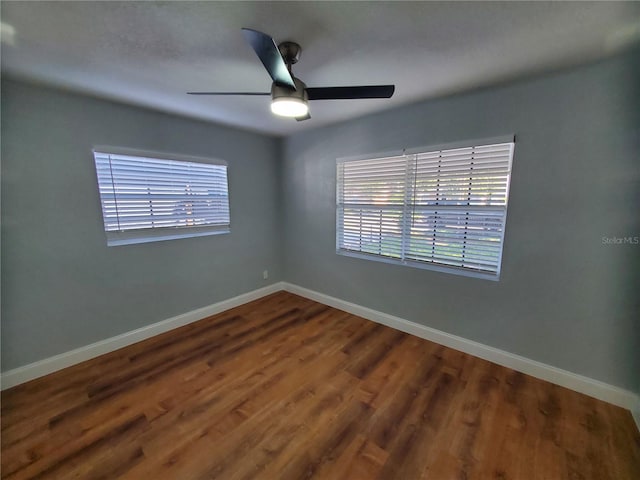 spare room featuring hardwood / wood-style floors and ceiling fan