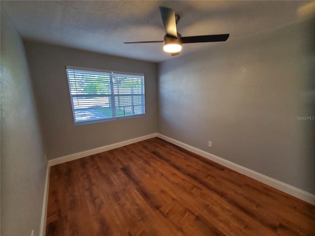 empty room with ceiling fan and wood-type flooring