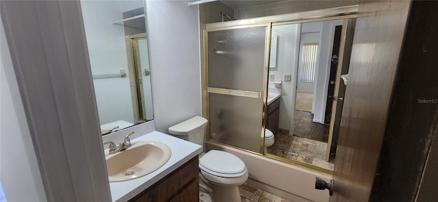 full bathroom with toilet, vanity, and bath / shower combo with glass door