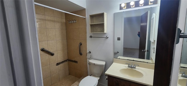 bathroom featuring vanity, toilet, and a tile shower