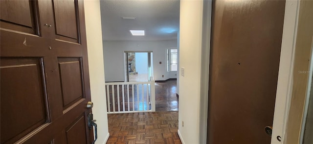 hall featuring dark parquet floors and a textured ceiling