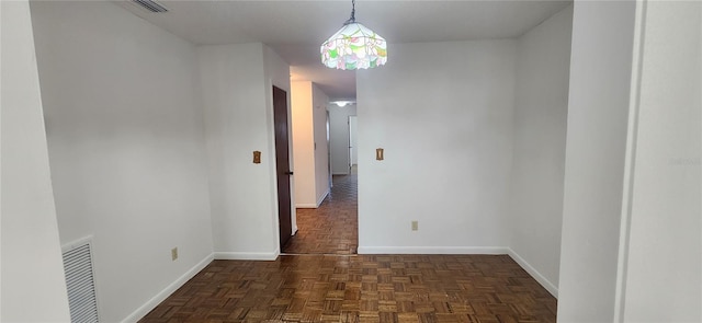 spare room with dark parquet floors