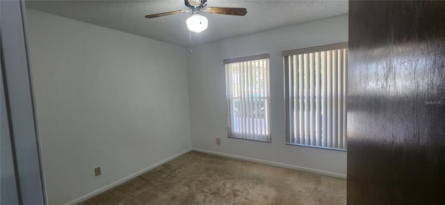 spare room featuring ceiling fan, a textured ceiling, and carpet flooring