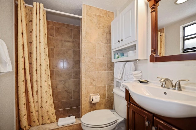 full bathroom with a stall shower, vanity, and toilet