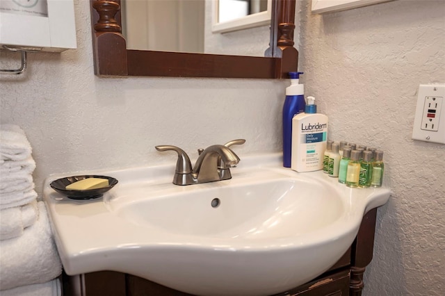 bathroom with a textured wall and a sink