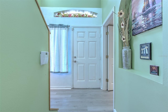 corridor with light hardwood / wood-style flooring