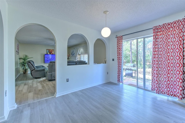 empty room featuring hardwood / wood-style flooring and a textured ceiling