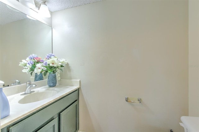 bathroom with vanity and a textured ceiling