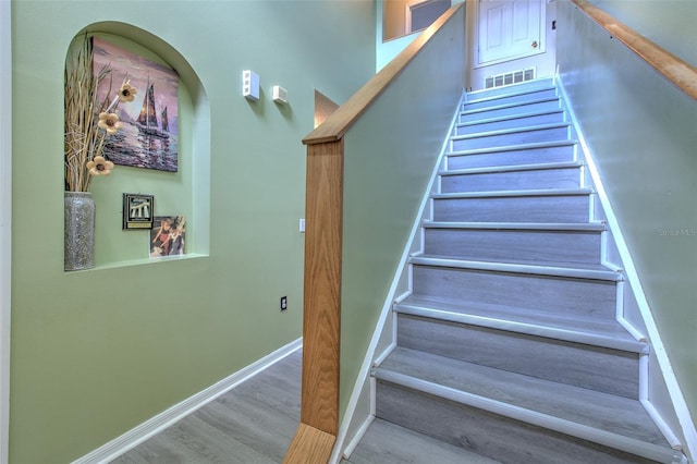 stairs with hardwood / wood-style flooring