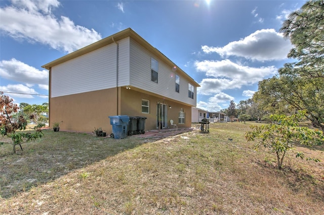 rear view of house with a yard