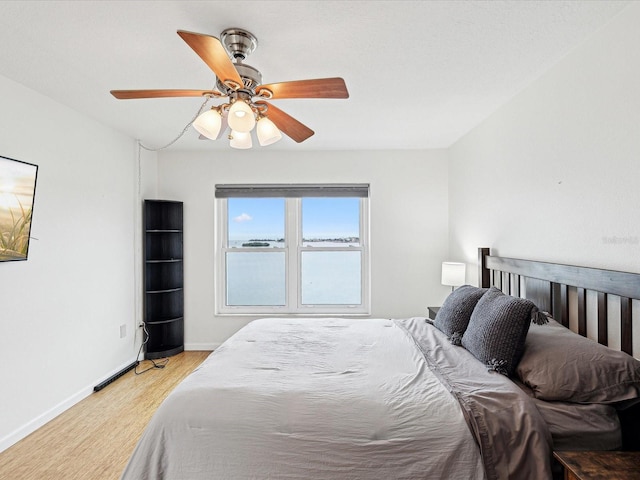 bedroom featuring ceiling fan and light hardwood / wood-style flooring