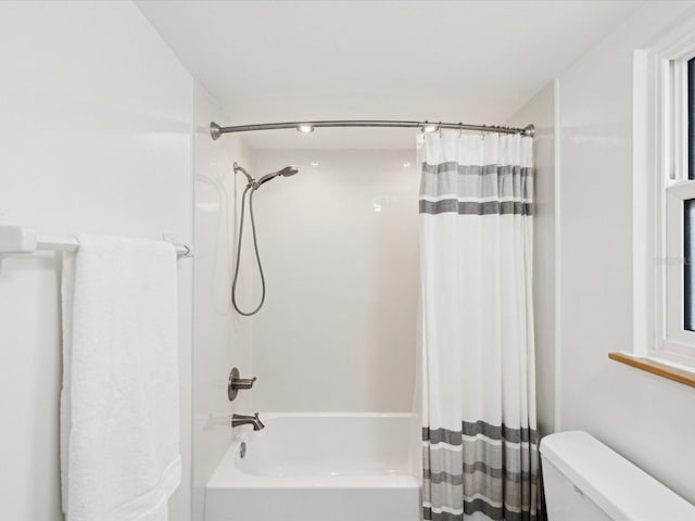 bathroom with toilet and shower / bath combo