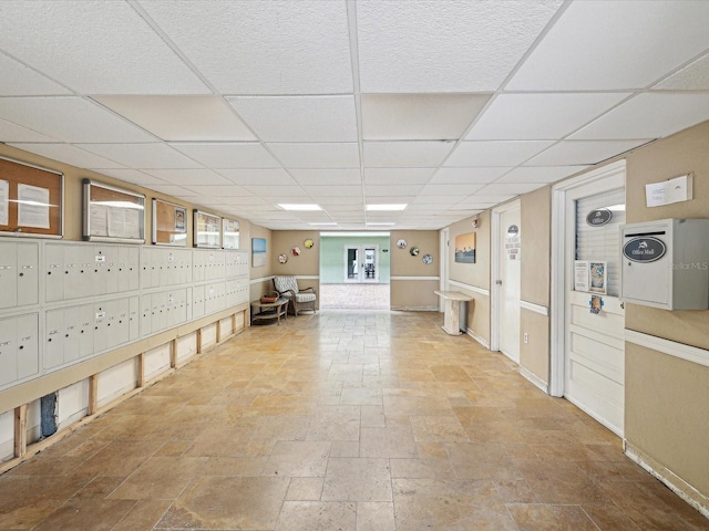 interior space with a drop ceiling and mail boxes